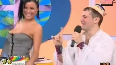 Raven-haired bombshell's jugs bust out of her shirt as she is dancing