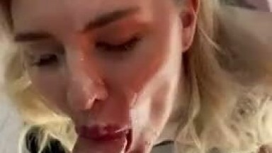 A blonde girl jerks off a dick that cums on her face
