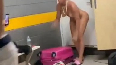 The naked lady is not shy about changing clothes in public