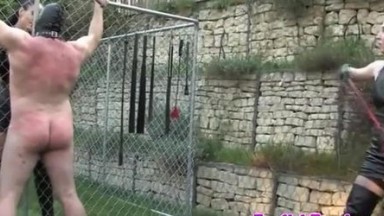 Femdom harshly punish sub with whips outdoor
